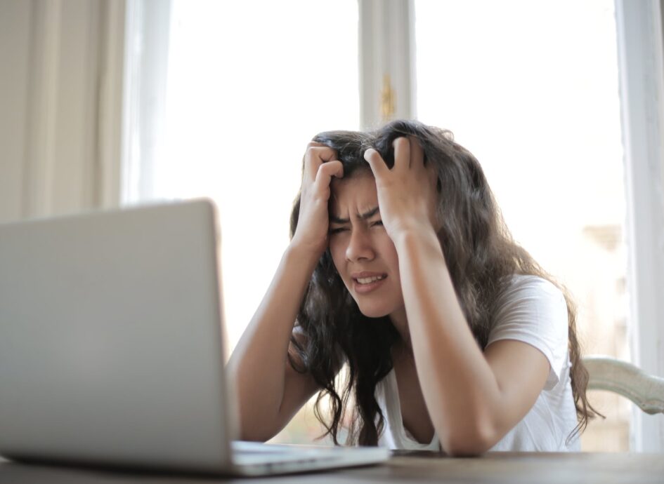 woman in white shirt showing frustration